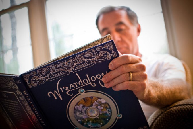Image: Man Reading Wizardology Book