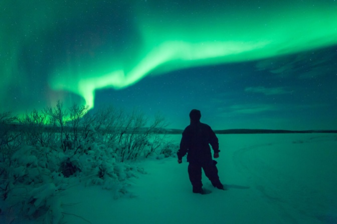 Image: Northern Lights Figure Standing in Snow